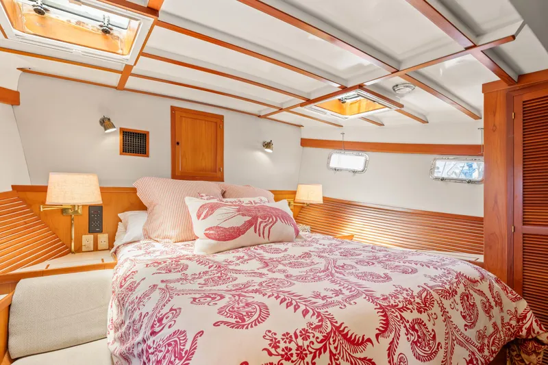 Cozy bedroom in 1996 Kadey-Krogen 48 Whaleback yacht with nautical decor.