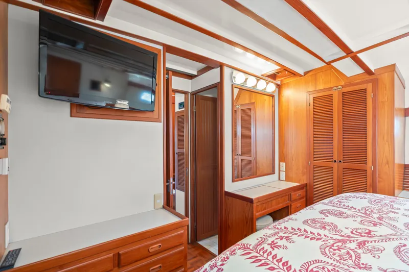 Luxurious 1996 Kadey-Krogen 48 Whaleback cabin with wood paneling and modern amenities.