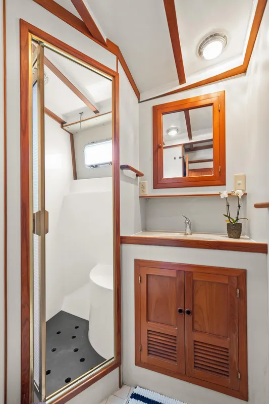 1996 Kadey-Krogen 48 Whaleback bathroom with wood accents and shower.