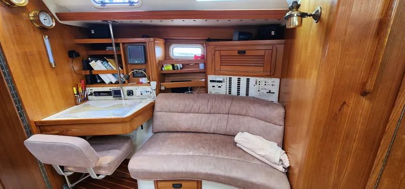 Interior of 1995 Catalina 42 MkII sailboat with navigation station and seating area.