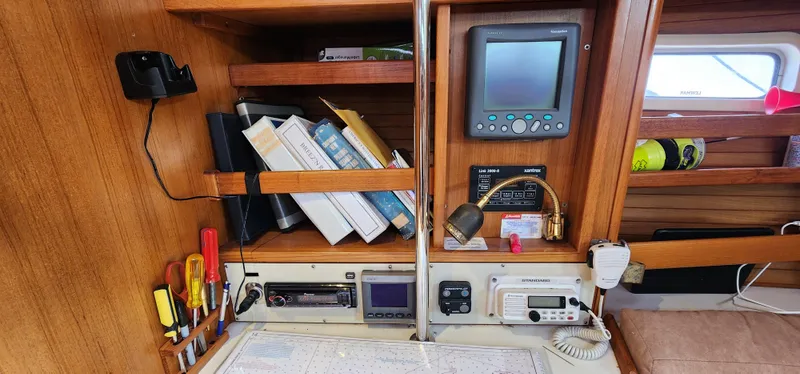Navigation station on a 1995 Catalina 42 MkII sailboat with charts and instruments.