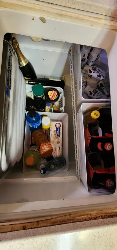 Refrigerator stocked with drinks and condiments on a 1995 Catalina 42 MkII boat.