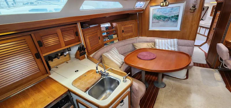 Interior of 1995 Catalina 42 MkII sailboat with kitchen and dining area.