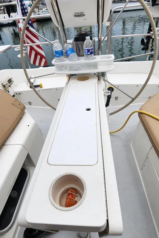 Cockpit of 1995 Catalina 42 MkII sailboat with steering wheel and drink holders.