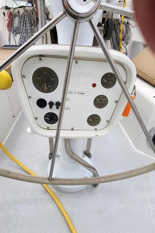 Steering console of a 1995 Catalina 42 MkII sailboat with gauges and controls.