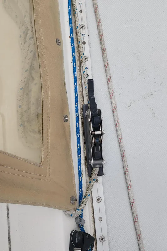 Close-up of Catalina 42 MkII sailboat rigging, featuring ropes and a pulley system.