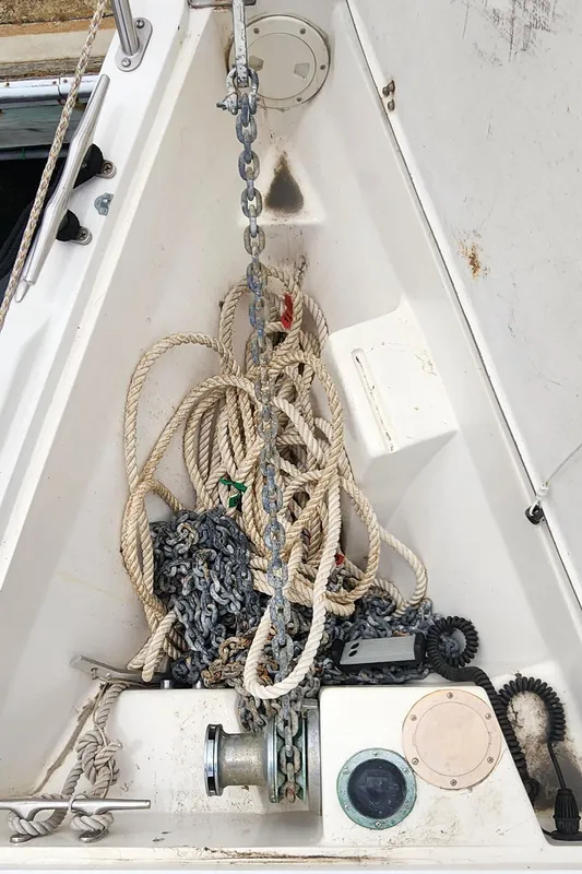 Anchor locker of a 1995 Catalina 42 MkII sailboat with ropes and chains.