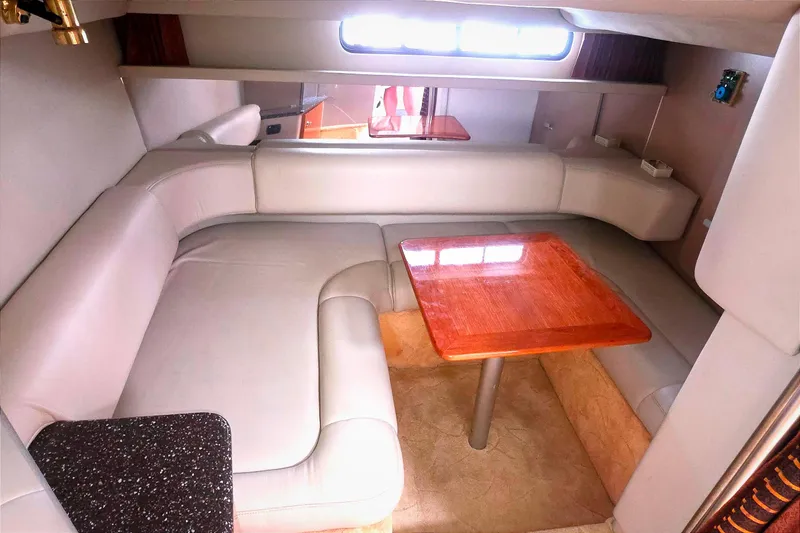 Interior of 2004 Formula 31 Performance Cruiser with beige seating and wooden table.