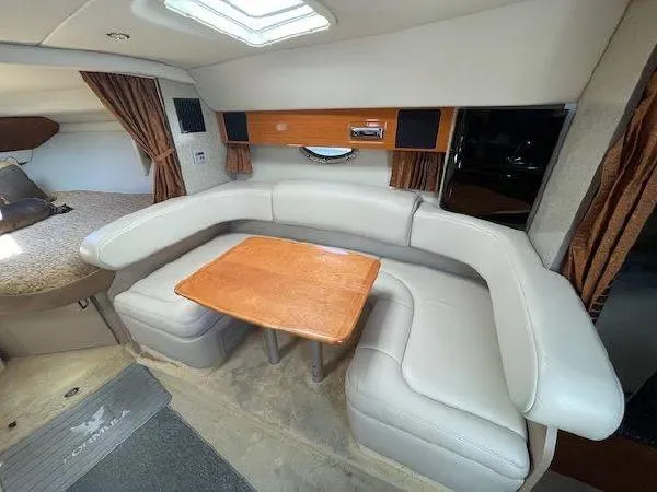 Interior of 2004 Formula 31 Performance Cruiser with leather sofa and wooden table.