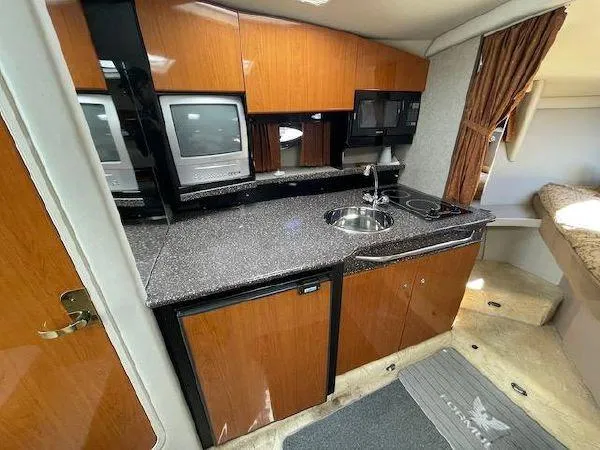 Interior of a 2004 Formula 31 Performance Cruiser with kitchenette and TV.