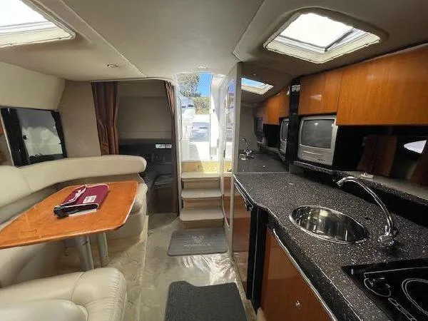 Interior of a 2004 Formula 31 Performance Cruiser with kitchen and seating area.