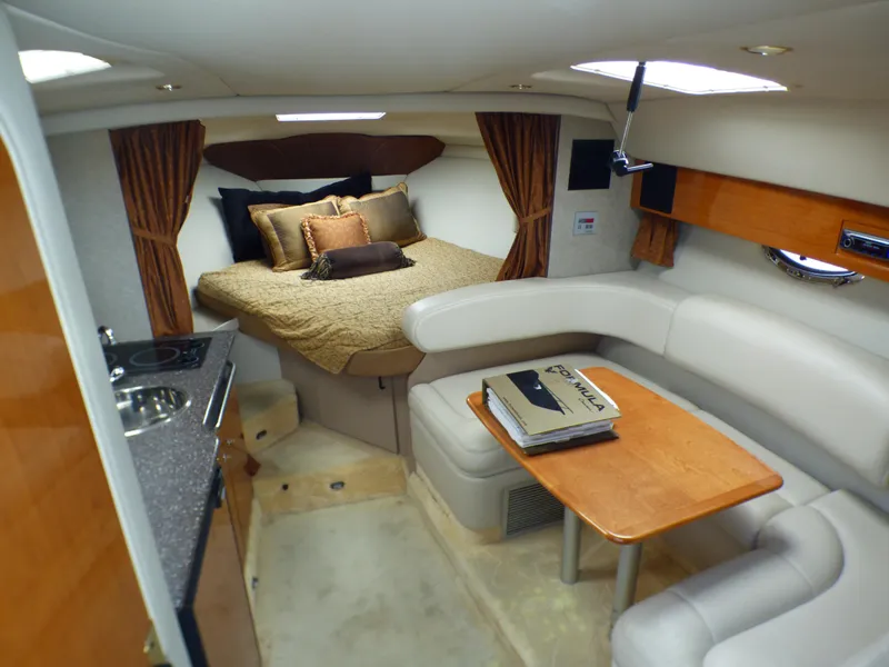 Interior of a 2004 Formula 31 Performance Cruiser with bed and seating area.