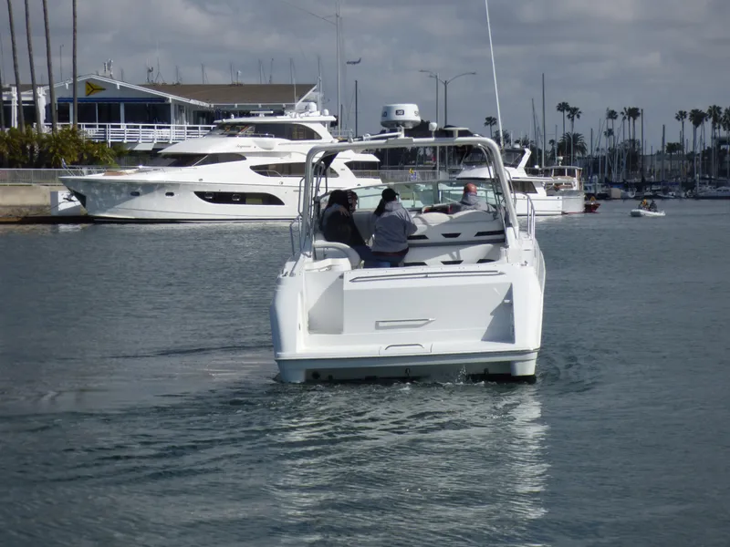 2004 Formula 31 Performance Cruiser in harbor, surrounded by yachts.