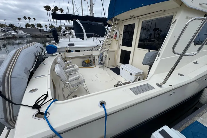 1983 Hatteras 36 Convertible yacht docked, featuring spacious deck and seating area.