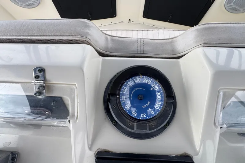 Compass on 1983 Hatteras 36 Convertible boat dashboard, showcasing navigation equipment.