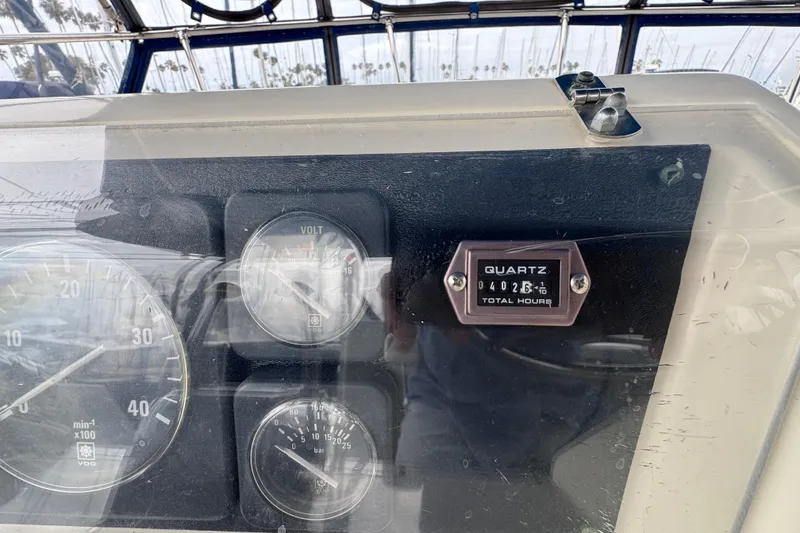 Instrument panel of 1983 Hatteras 36 Convertible boat showing gauges and hour meter.