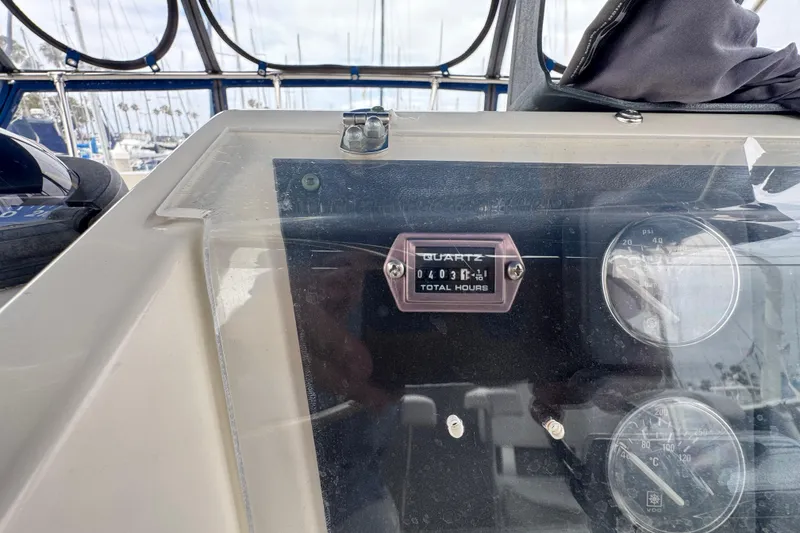 Dashboard of 1983 Hatteras 36 Convertible showing total engine hours and gauges.