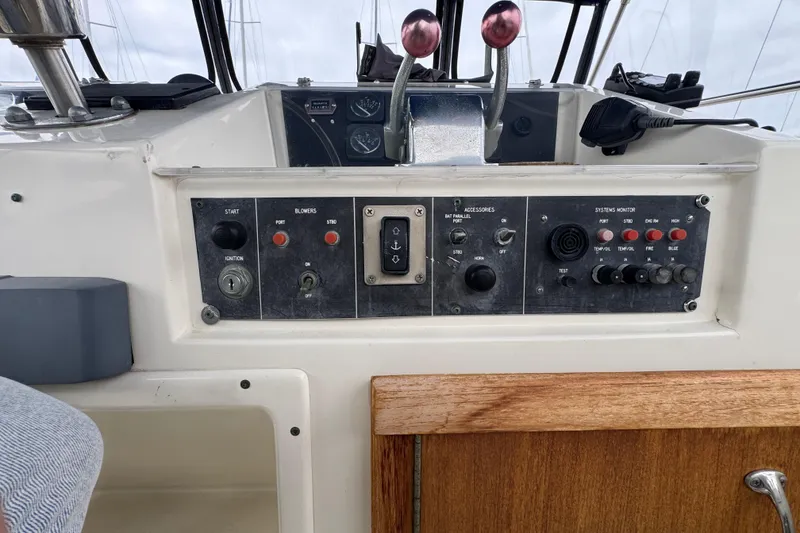 Control panel of a 1983 Hatteras 36 Convertible boat with various switches and gauges.