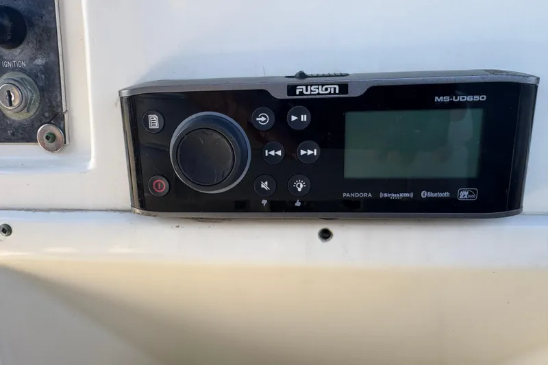 Fusion MS-UD650 stereo system on 1983 Hatteras 36 Convertible boat dashboard.