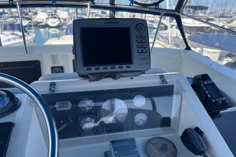 Helm of 1983 Hatteras 36 Convertible with navigation equipment and gauges.