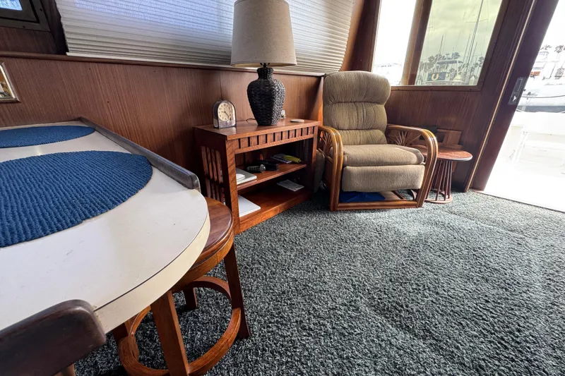 Interior of 1983 Hatteras 36 Convertible yacht with cozy seating and nautical decor.