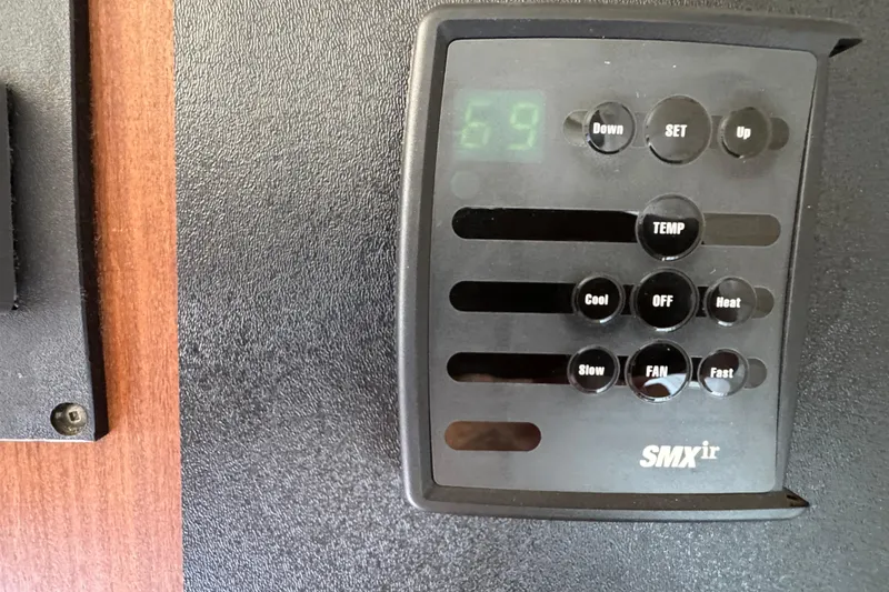 Thermostat control panel on 1983 Hatteras 36 Convertible boat interior.