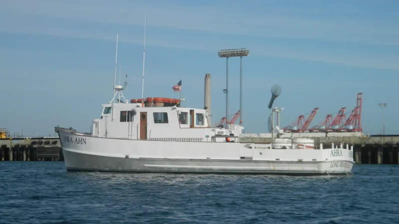 1958 Ditmar & Donaldson sport boat docked near industrial port.