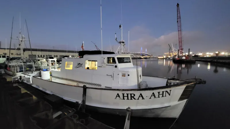 1958 Ditmar & Donaldson sport boat docked at night, named "AHRA AHN".