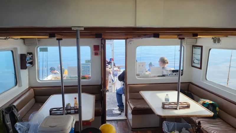 Interior of a 1958 Ditmar & Donaldson sport boat with seating and ocean view.