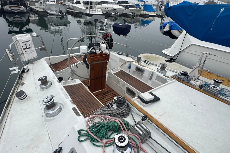 Cockpit view of 1985 Beneteau First 38 sailboat docked in marina.