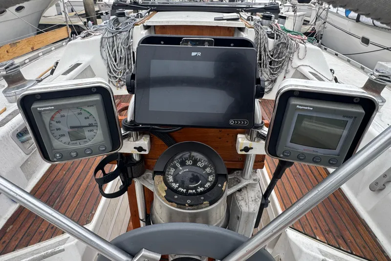 Cockpit of 1985 Beneteau First 38 sailboat with navigation instruments and compass.