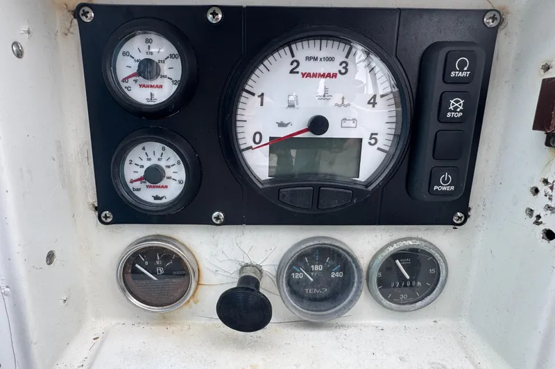 Control panel of a 1985 Beneteau First 38 sailboat with Yanmar engine gauges.