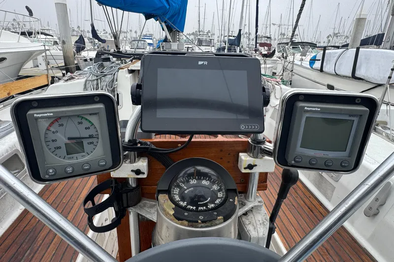 Cockpit of 1985 Beneteau First 38 sailboat with navigation instruments and compass.
