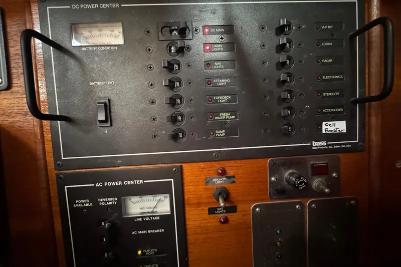 Electrical control panel on a 1985 Beneteau First 38 sailboat, featuring DC and AC power centers.