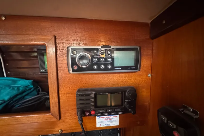 Control panel inside 1985 Beneteau First 38 sailboat, featuring radio and navigation equipment.