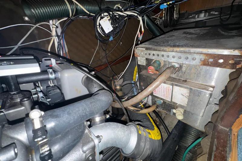 Engine compartment of a 1985 Beneteau First 38 sailboat, showing wiring and components.