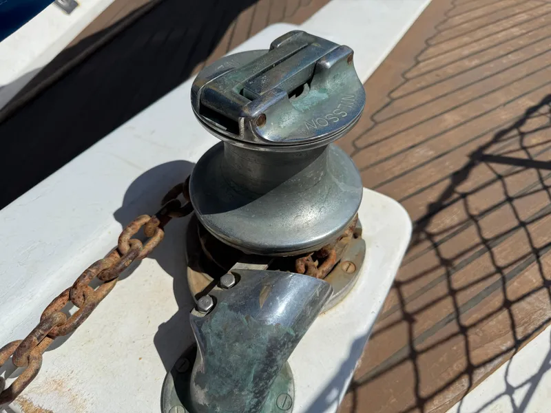 Anchor windlass on 1986 Vagabond 47 sailboat deck with chain.