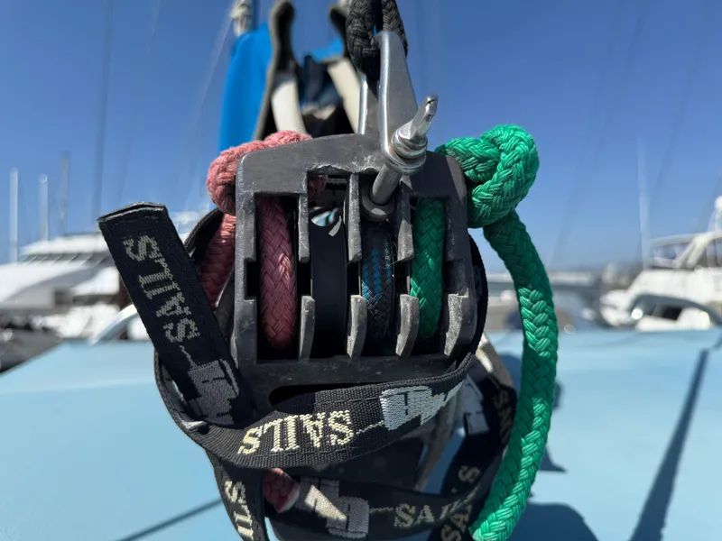 Close-up of colorful ropes and cleat on a 1986 Vagabond 47 sailboat deck.