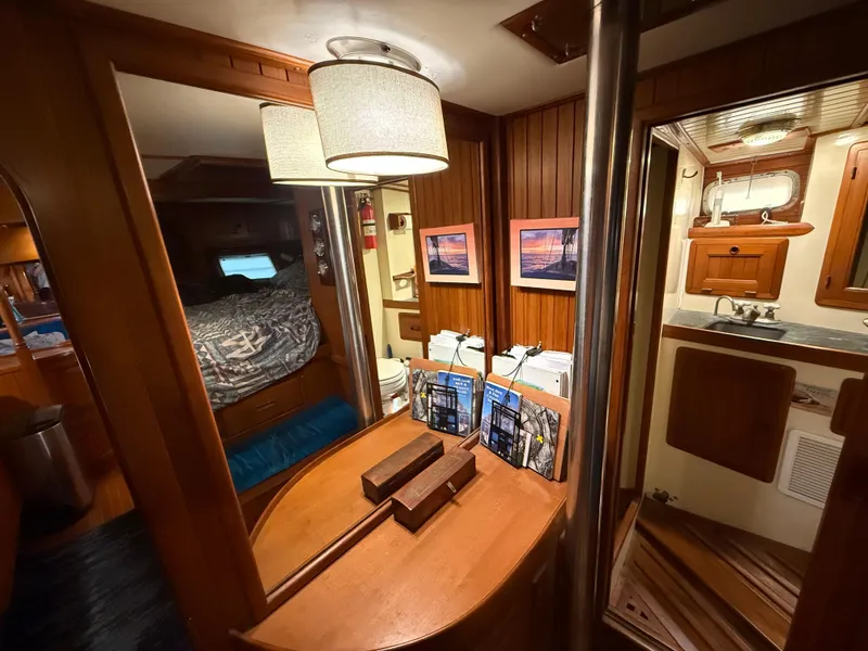Interior of 1986 Vagabond 47 sailboat with cozy cabin and wooden furnishings.