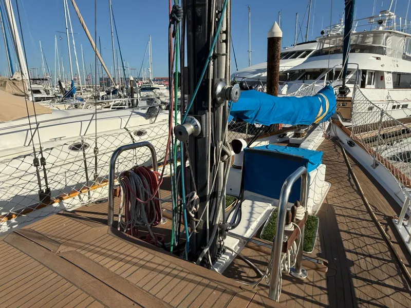 Sailboat deck of 1986 Vagabond 47, docked in marina with blue sail cover.