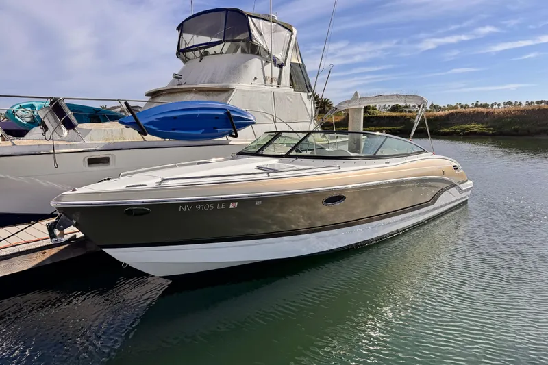 2012 Formula 290 Sun Sport boat docked in a marina under clear skies.