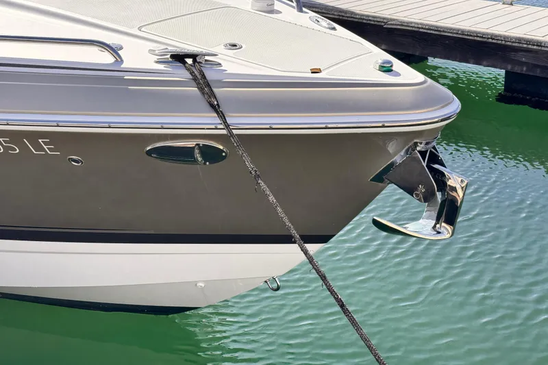 2012 Formula 290 Sun Sport boat anchored at a marina, showing sleek design and chrome anchor.