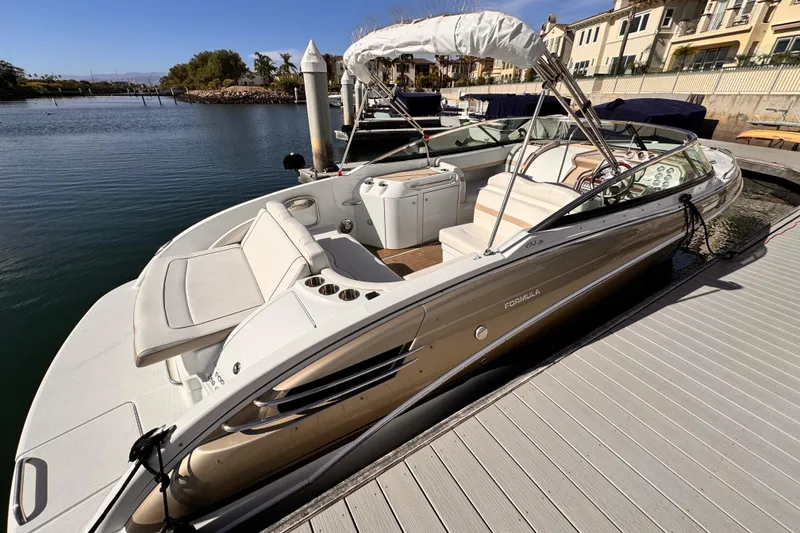 2012 Formula 290 Sun Sport boat docked at marina, featuring sleek design and spacious seating.