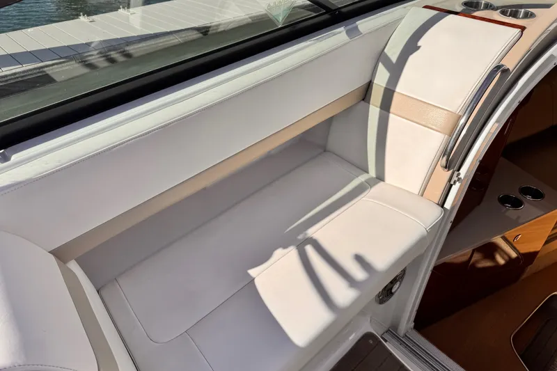 2012 Formula 290 Sun Sport boat interior with white seating and cup holders.