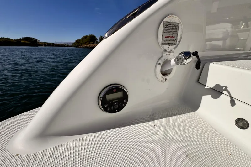 2012 Formula 290 Sun Sport boat deck with control panel and water outlet.