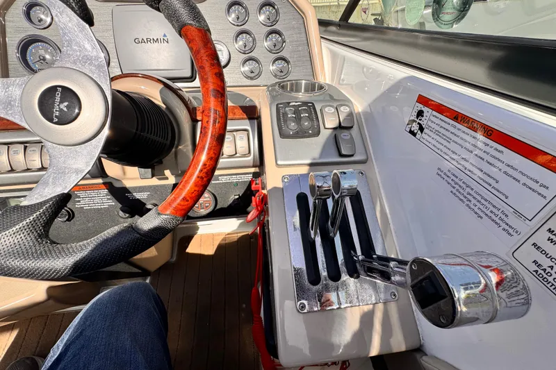2012 Formula 290 Sun Sport dashboard with steering wheel, controls, and Garmin display.