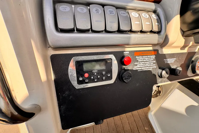 Control panel of a 2012 Formula 290 Sun Sport boat with switches and warning label.