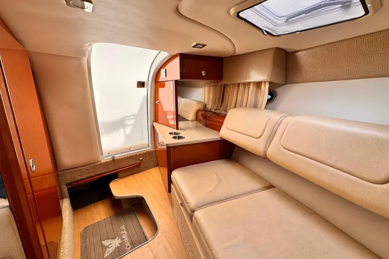 Interior of 2012 Formula 290 Sun Sport boat with beige seating and wooden accents.