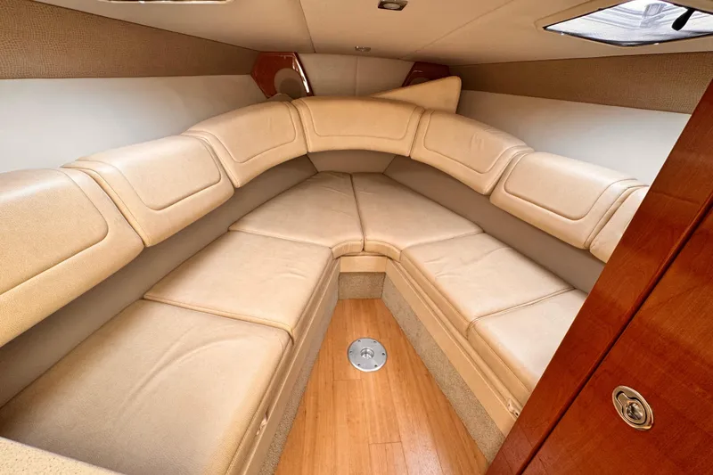 2012 Formula 290 Sun Sport cabin interior with beige seating and wood accents.