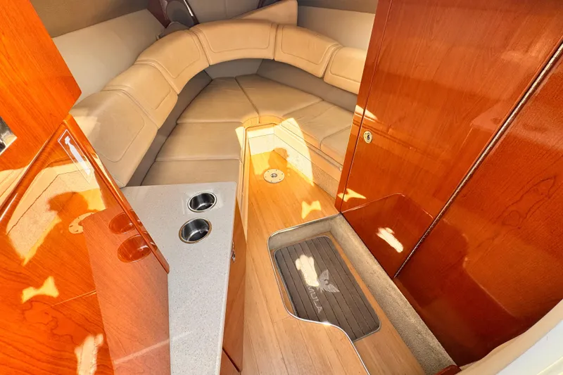 Luxurious interior of 2012 Formula 290 Sun Sport boat with plush seating and wood finishes.